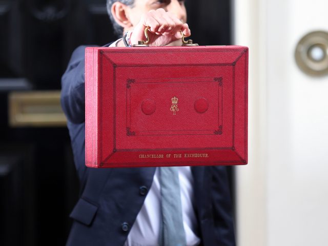 Rishi Sunak holds the red dispatch box outside 11 Downing Street ahead of revealing the budget in the House of Commons