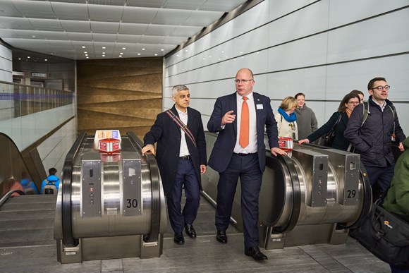 Mayor of London walking up escalator