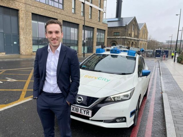 Max Sugarman in front of a self driving car